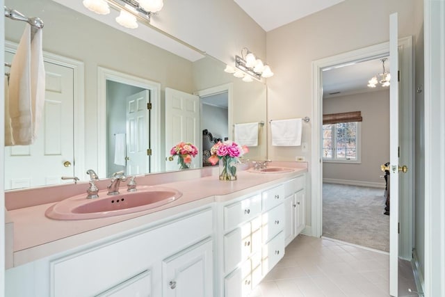 bathroom featuring tile patterned floors, vanity, and a chandelier