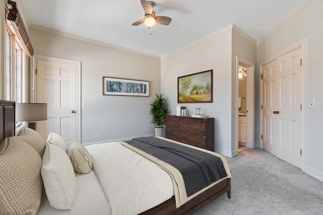 bedroom with ceiling fan, crown molding, light colored carpet, and ensuite bath