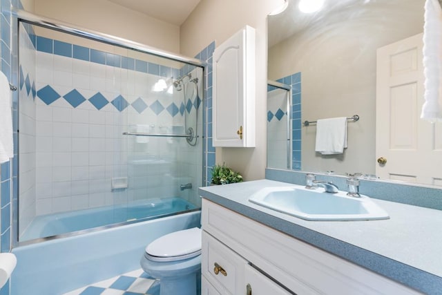 full bathroom with toilet, vanity, and shower / bath combination with glass door