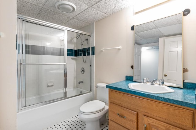 full bathroom featuring combined bath / shower with glass door, vanity, and toilet