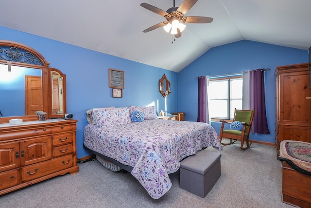 bedroom featuring ceiling fan, vaulted ceiling, and light carpet