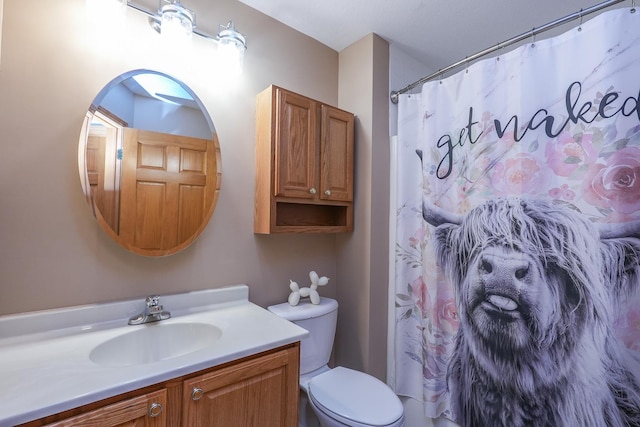 bathroom featuring toilet, vanity, and a shower with shower curtain