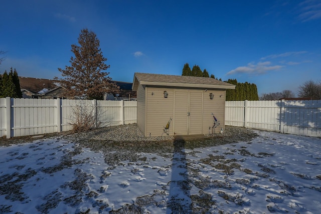 yard covered in snow with a storage unit