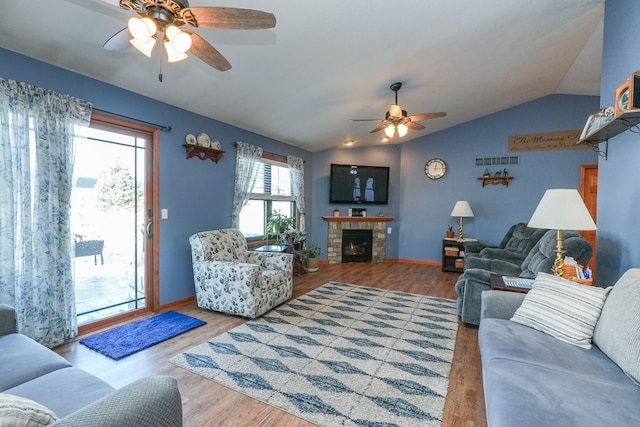 living room with ceiling fan, lofted ceiling, a fireplace, and hardwood / wood-style flooring