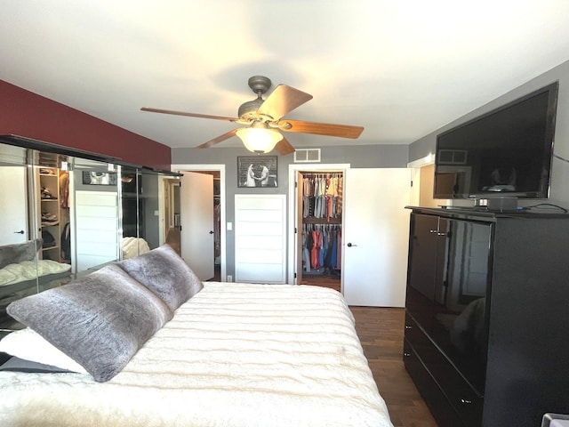 bedroom with a closet, ceiling fan, and dark hardwood / wood-style flooring