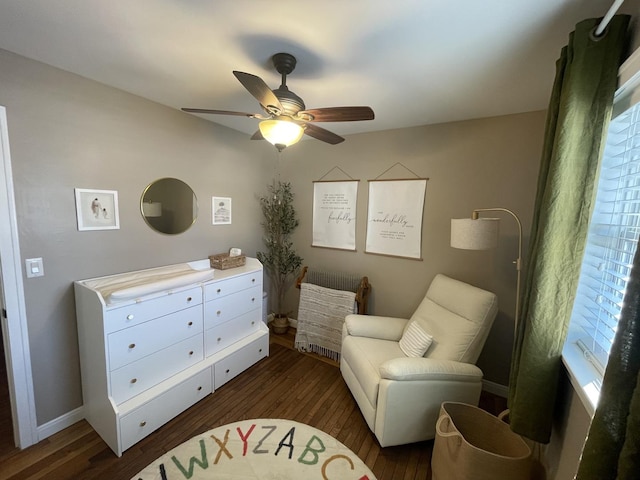 sitting room with ceiling fan and dark hardwood / wood-style floors