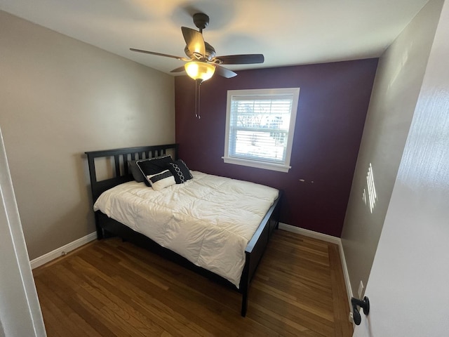 bedroom with dark wood-type flooring and ceiling fan