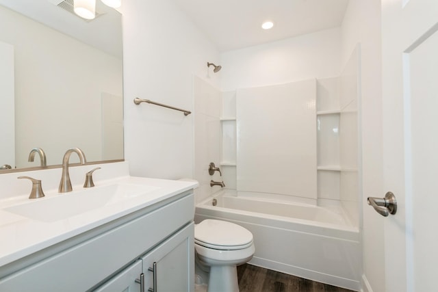 full bathroom featuring toilet, bathing tub / shower combination, wood-type flooring, and vanity