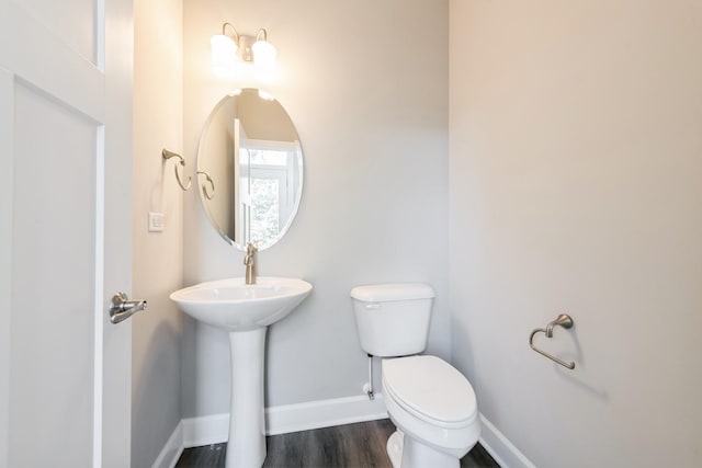 bathroom with sink, hardwood / wood-style floors, and toilet