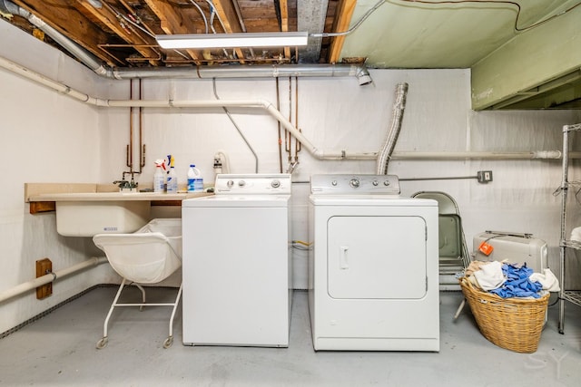 laundry room with washer and clothes dryer and sink