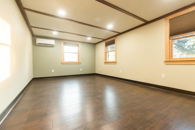 spare room featuring dark hardwood / wood-style floors, a wall unit AC, and a healthy amount of sunlight