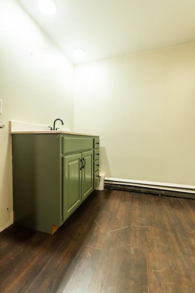 bathroom with wood-type flooring and a baseboard radiator