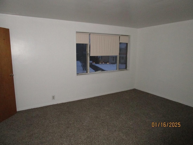 empty room featuring dark colored carpet