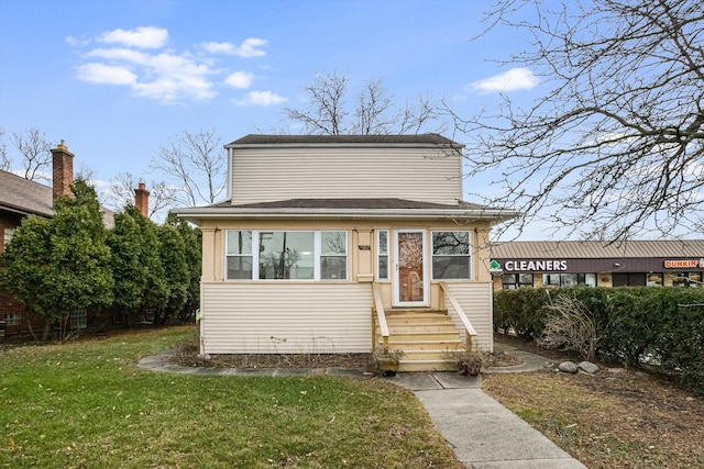 bungalow-style home with a front yard