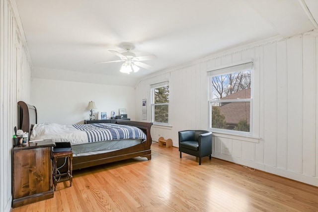 bedroom with ceiling fan, light wood-type flooring, and lofted ceiling