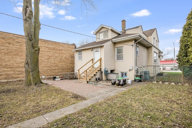 back of house with a lawn and central AC