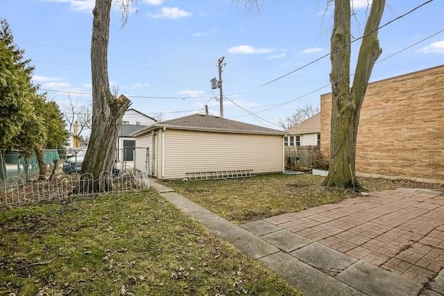 view of property exterior featuring a patio area and a yard