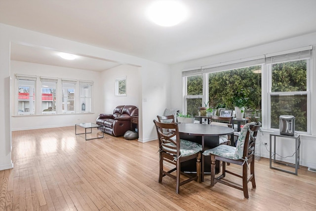 dining space with light hardwood / wood-style floors