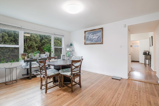 dining space with light hardwood / wood-style flooring