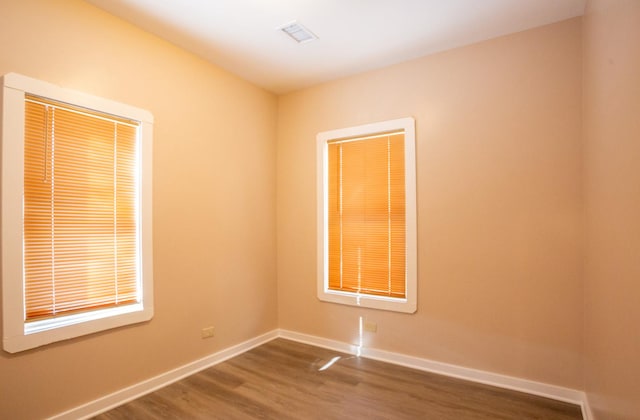 unfurnished room with dark hardwood / wood-style flooring