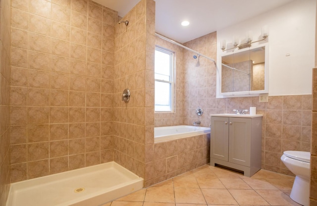 full bathroom featuring toilet, independent shower and bath, tile walls, and tile patterned floors