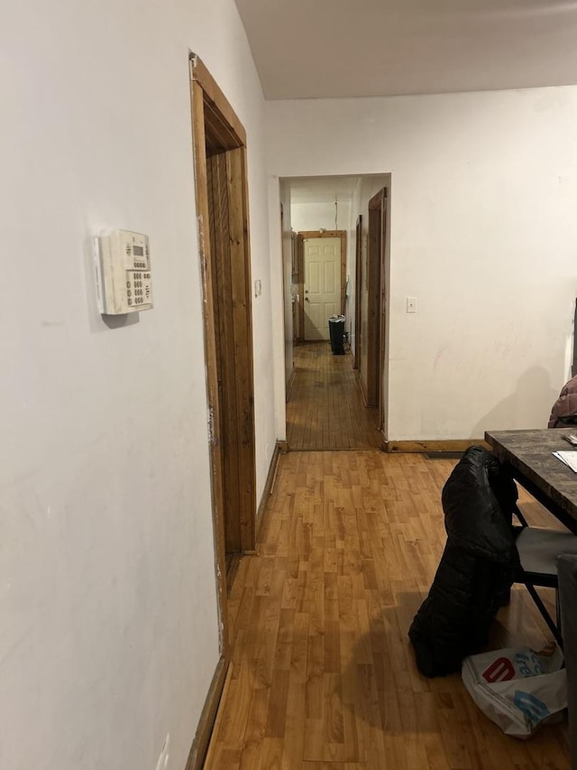 corridor with hardwood / wood-style flooring