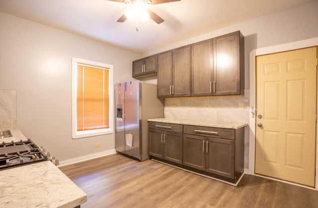 kitchen featuring light hardwood / wood-style floors, stainless steel refrigerator with ice dispenser, ceiling fan, tasteful backsplash, and dark brown cabinetry