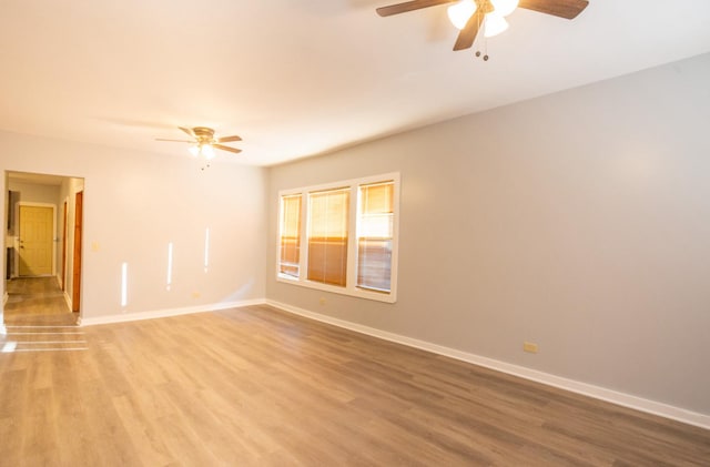 unfurnished room featuring ceiling fan and hardwood / wood-style floors