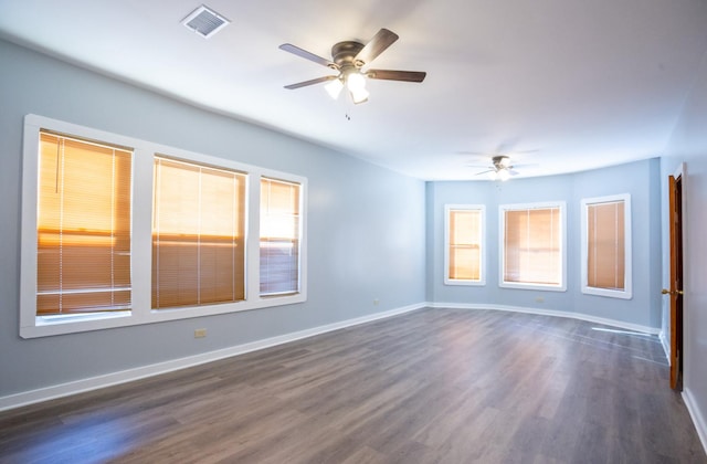 spare room with ceiling fan and dark hardwood / wood-style floors