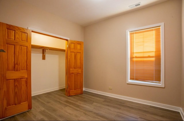 unfurnished bedroom featuring dark hardwood / wood-style floors