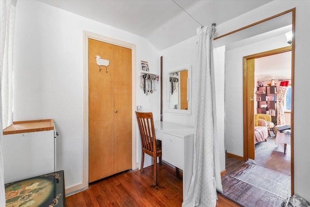 foyer entrance with dark hardwood / wood-style floors and lofted ceiling