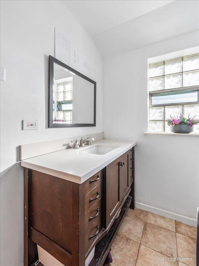 bathroom featuring vanity and vaulted ceiling