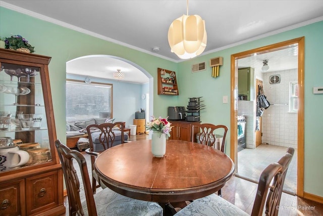 dining area with crown molding