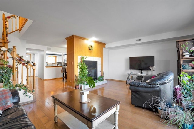 living room featuring light hardwood / wood-style flooring and a fireplace