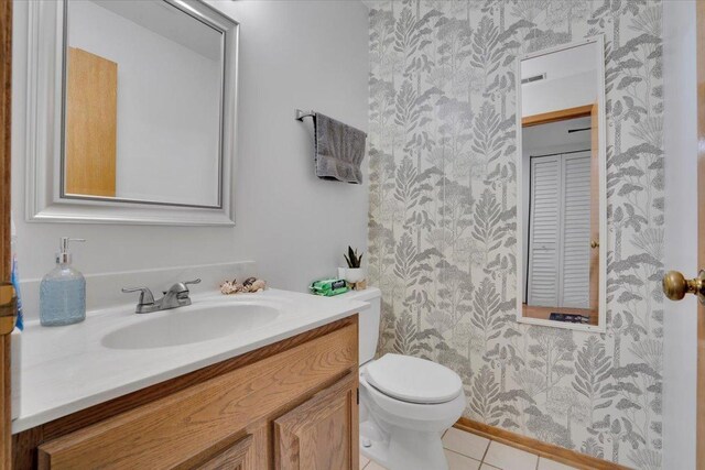 bathroom featuring vanity, toilet, and tile patterned floors