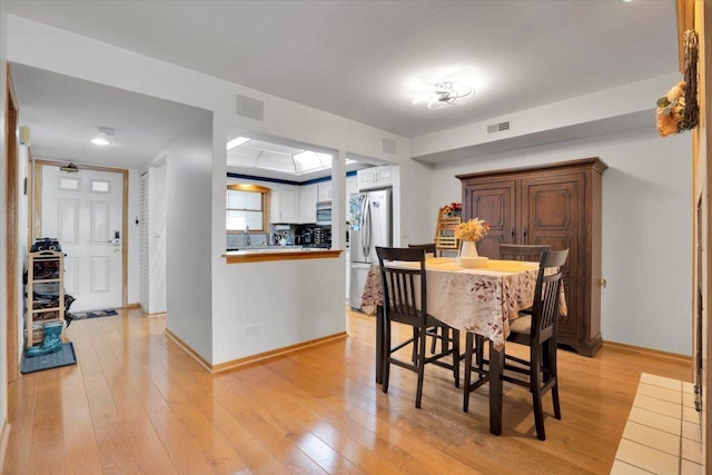 dining area with light hardwood / wood-style floors