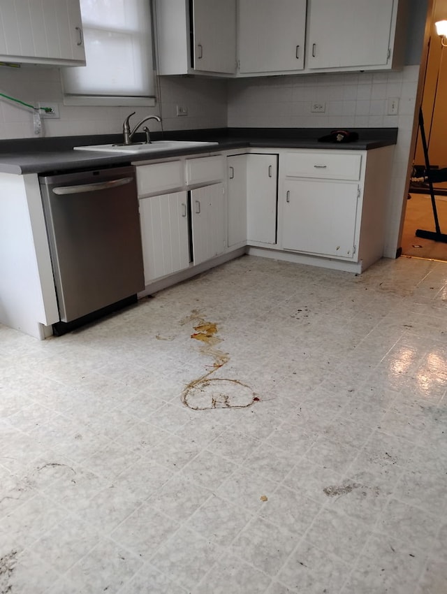 kitchen featuring tasteful backsplash, stainless steel dishwasher, and sink