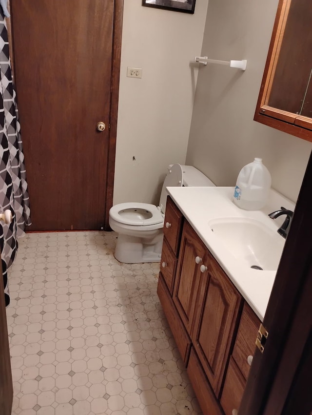 bathroom featuring vanity and toilet