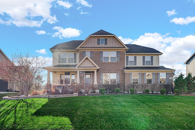 craftsman-style house featuring covered porch and a front yard