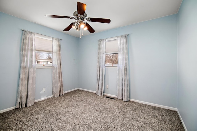 unfurnished room featuring ceiling fan and carpet