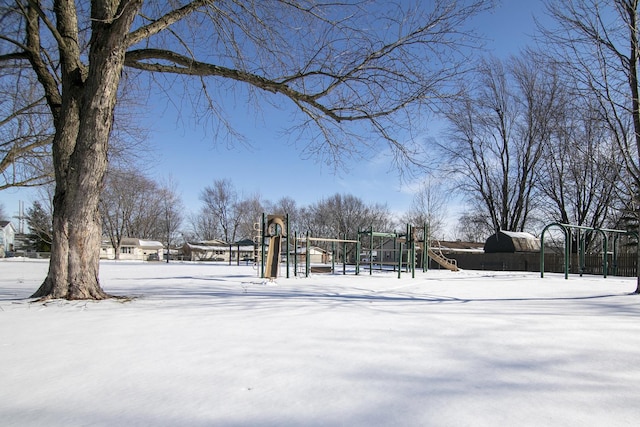 yard layered in snow with a playground