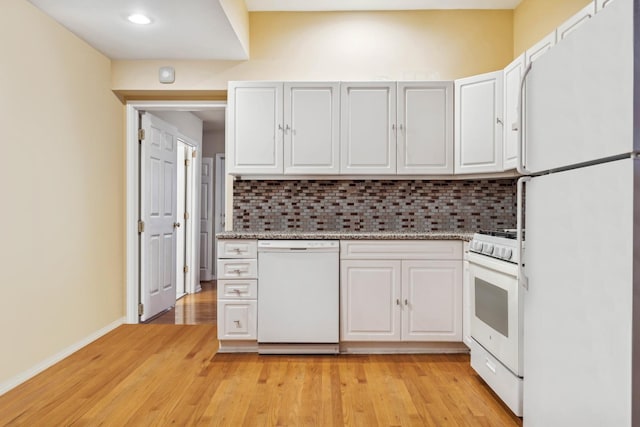 kitchen with decorative backsplash, white appliances, white cabinetry, and light hardwood / wood-style floors