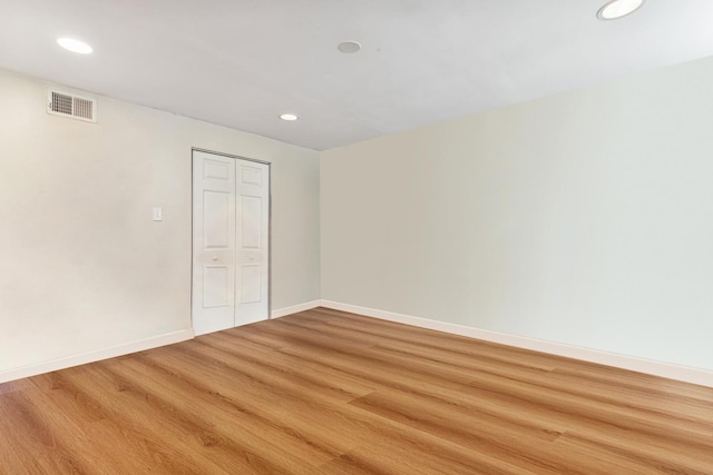 unfurnished bedroom with a closet and hardwood / wood-style floors