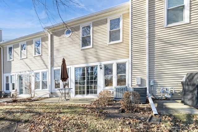 rear view of property featuring central AC and a patio