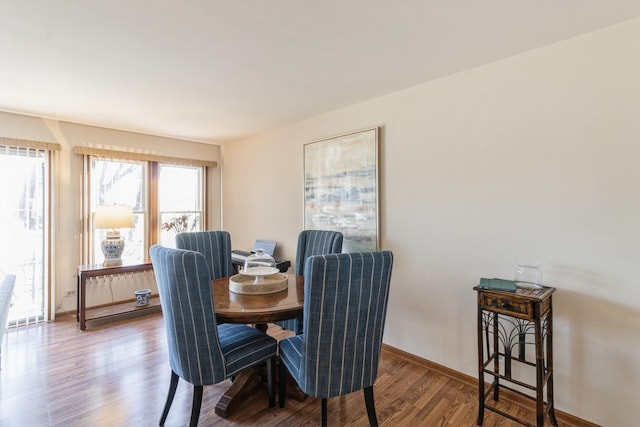 dining space with hardwood / wood-style flooring