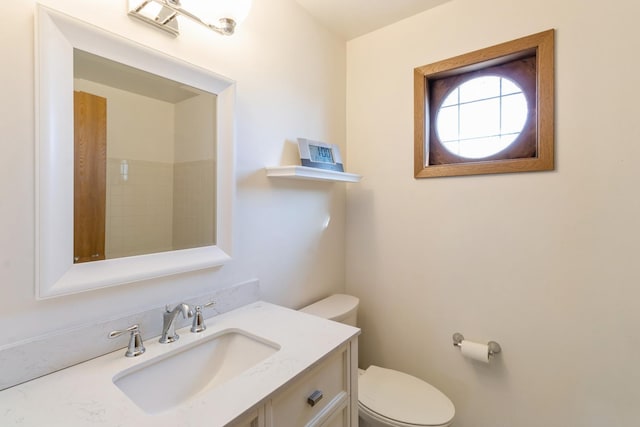 bathroom featuring toilet and vanity