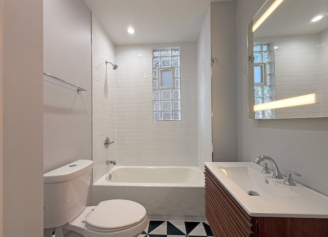 full bathroom with tiled shower / bath combo, vanity, and toilet