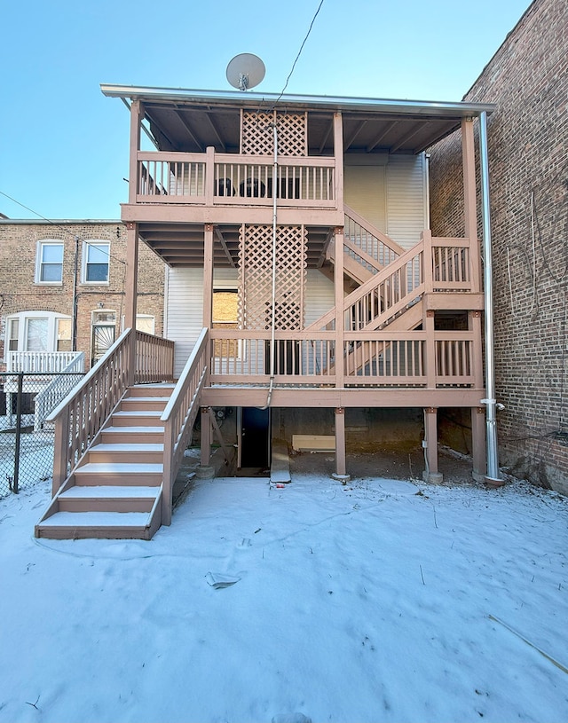 view of snow covered back of property