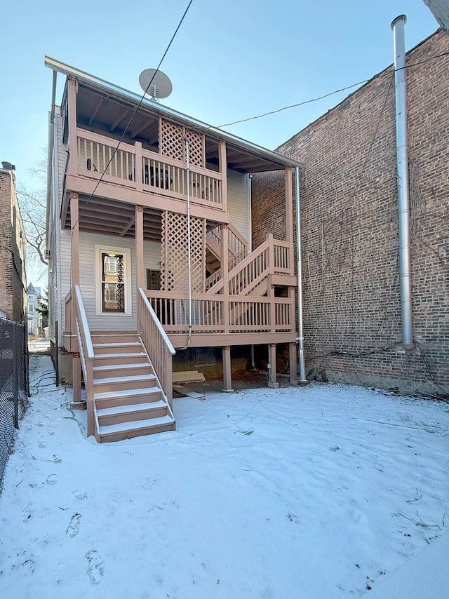 view of snow covered rear of property