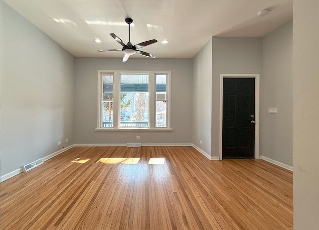 empty room with light hardwood / wood-style flooring and ceiling fan